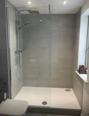 a shower with a glass door in a bathroom at Spacious 4 Bed house Perfect for Contractors-Relocators in Harlow