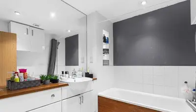 a white bathroom with a tub and a sink at Spacious 4 Bed house Perfect for Contractors-Relocators in Harlow