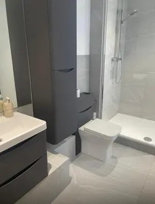 a bathroom with a toilet and a sink and a shower at Spacious 4 Bed house Perfect for Contractors-Relocators in Harlow