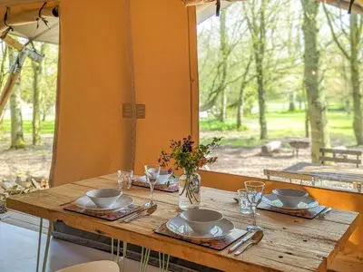 a wooden table with plates and dishes on it with a window at The Bushel - Ukc7131 in Cratfield