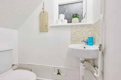 a white bathroom with a sink and a toilet at Surehaven Stays 6 Bedroom House Great for Teams in Colchester