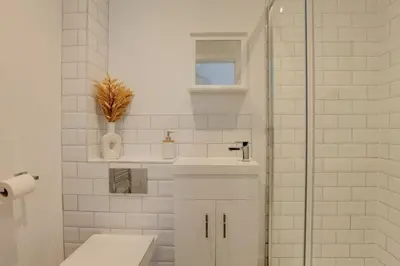 a white bathroom with a toilet and a sink at Surehaven Stays 4 Bedroom House Braintree in Braintree