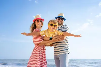 a group of three people standing on the beach at Lovely 8 Berth Caravan With Decking To Hire At Naze Marine In Essex Ref 17030Ga in Walton-on-the-Naze