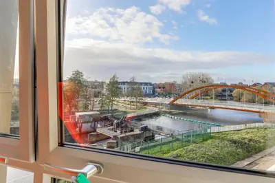 a window with a view of a river and a bridge at The Opulent Property Project ChelmsfordCityCentre 2Bed2Bath FreeParking Balcony in Chelmsford