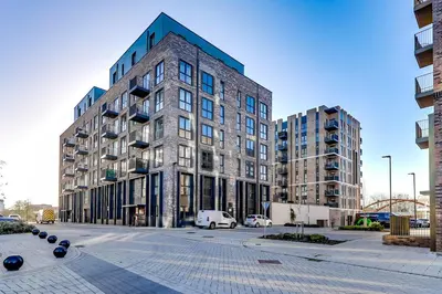 a tall building with a car parked in front of it at The Opulent Property Project ChelmsfordCityCentre 2Bed2Bath FreeParking Balcony in Chelmsford