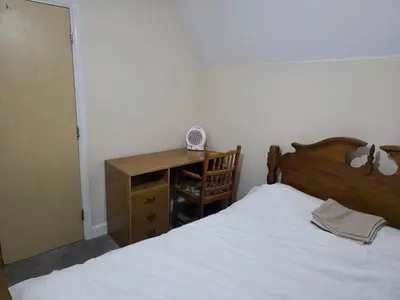 a bedroom with a bed and a dresser and a desk at Near Colchester hospital in Hythe