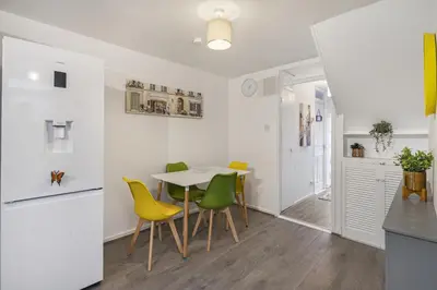 a kitchen and dining room with a table and chairs at Beautiful 3 bedroom house, Laindon, Basildon. in Laindon