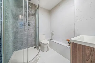 a bathroom with a shower and a toilet and a sink at College Lane Apartment, Bury St Edmunds in Bury Saint Edmunds