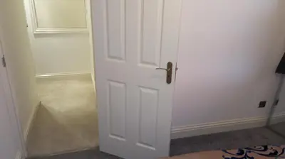 a white door in a room with a hallway at Cassandra Homes in Nevendon