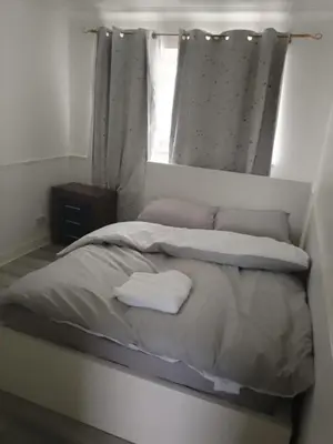 a bed in a room with a window and a bedvisor at APEX HOUSE Le Hope ENSUITE in Horndon on the Hill