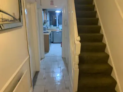 a hallway with a stairway leading to a kitchen at APEX HOUSE Le Hope ENSUITE in Horndon on the Hill