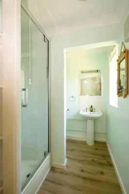 a bathroom with a shower and a sink at Rainbow Cottage in Thorpeness, Close to the Beach, Golf and the Country Club in Thorpeness