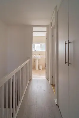 a hallway with a bathroom with a sink at Spacious 3-Bed Home with parking in Lexden