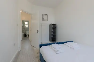a white room with a bed with towels on it at 2 Bedroom Flat in the heart of Southend Sleeps 6 - Pass the Keys in Southend-on-Sea