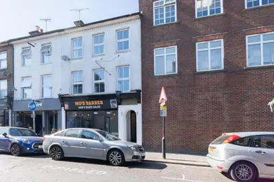 two cars parked in front of a brick building at 2 Bedroom Flat in the heart of Southend Sleeps 6 - Pass the Keys in Southend-on-Sea