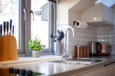 a kitchen counter with a sink and a window at Stylish and Modern Flat with Free Parking - Pass the Keys in Cambridge