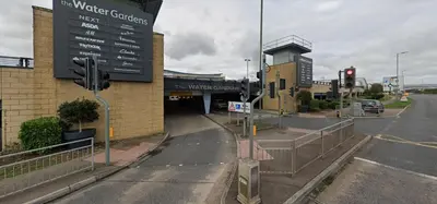 an empty street with a traffic light in front of a building at Harlow Flat - Perfect for Families or Contractors in Harlow