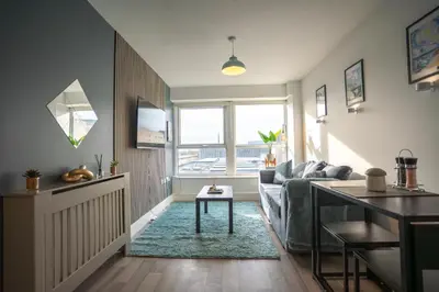 a living room with a couch and a table at Harlow Flat - Perfect for Families or Contractors in Harlow