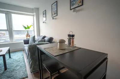 a living room with a table and a couch at Harlow Flat - Perfect for Families or Contractors in Harlow