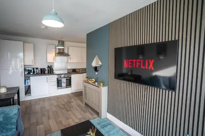 a living room with a television on a wall at Harlow Flat - Perfect for Families or Contractors in Harlow