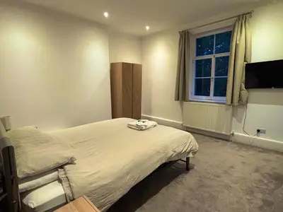 a bedroom with a bed and a window at Brandon House in Brandon