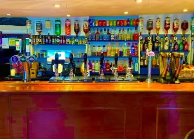 a bar with a lot of bottles of alcohol at Brandon House in Brandon