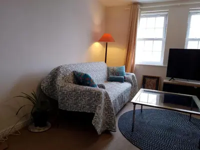 a living room with a chair and a coffee table at 2 Bed - Sleeps 4 - Free Parking in Ely