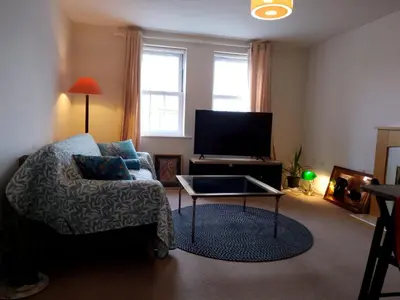 a living room with a couch and a tv at 2 Bed - Sleeps 4 - Free Parking in Ely