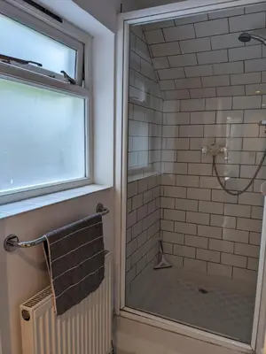 a shower with a glass door in a bathroom at Beautiful apartment in central Cambridge in Cambridge