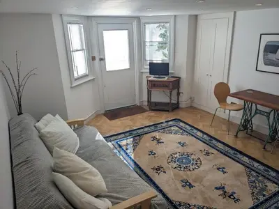 a living room with a couch and a table at Beautiful apartment in central Cambridge in Cambridge