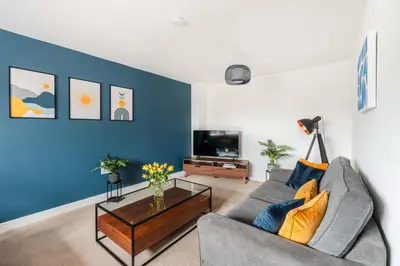 a living room with a gray couch and a blue wall at 4 Bed, 3 Bath Townhouse in Colchester - Business, Contractor and Leisure - Singles or Superkings - Disc0unts in Lexden
