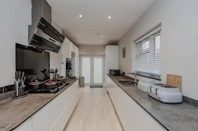 a kitchen with white walls and a counter top at New 4BR Gem, Central, 3 Car Drive, Contractor Stay in South Benfleet