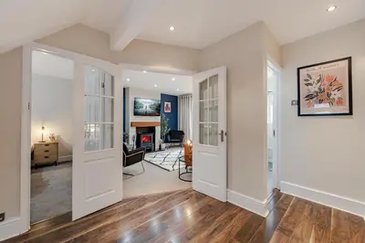 an open living room with white walls and wood floors at New 4BR Gem, Central, 3 Car Drive, Contractor Stay in South Benfleet