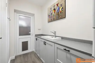 a white bathroom with a sink and a window at 4 Bed, 2 Bath Detached House, Parking, Fast Wifi in Colchester