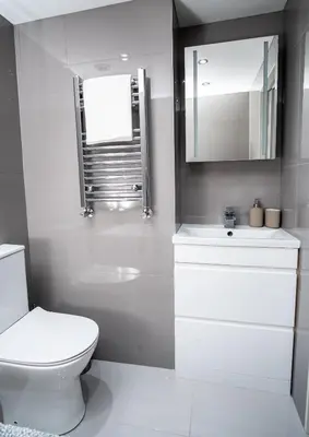 a bathroom with a toilet and a sink and a mirror at Modern cottage! 5 mins from central line! in Theydon Bois
