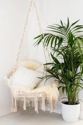 a white swing with a blanket and a plant at Modern cottage! 5 mins from central line! in Theydon Bois