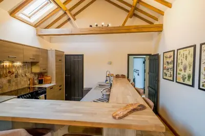 a large kitchen with a long counter in the middle at An elegant countryside hideaway with four indulgent ensuite bedrooms in Fressingfield