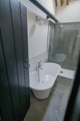 a bathroom with a sink and a bath tub at An elegant countryside hideaway with four indulgent ensuite bedrooms in Fressingfield