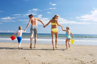 a family running on the beach at Seawick, 4 Bed, 10 Berth Caravan With Central Lounge, Dg & Ch Opal Rated in Clacton-on-Sea