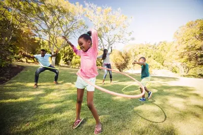 a group of children playing with a hula hoop at Seawick, 4 Bed, 10 Berth Caravan With Central Lounge, Dg & Ch Opal Rated in Clacton-on-Sea