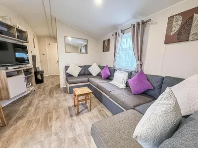 a living room with couches and purple pillows at Seawick, 4 Bed, 10 Berth Caravan With Central Lounge, Dg & Ch Opal Rated in Clacton-on-Sea