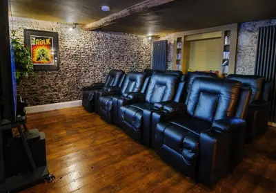 a group of leather chairs in a room at Luxury Rock & Roll Suite in Manor House in Saffron Walden