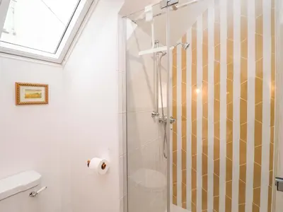 a bathroom with a shower with a glass door at 52 Lee Road in Aldeburgh