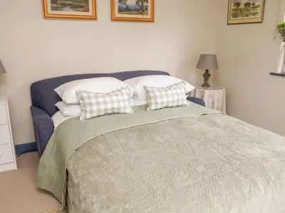 a bedroom with a bed with two pillows on it at 52 Lee Road in Aldeburgh
