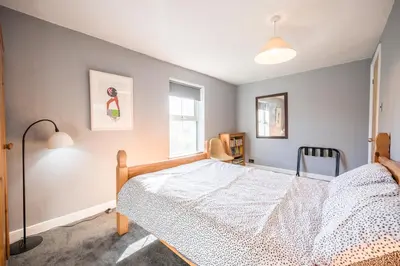 a bedroom with a bed and a window at The Knoll, Alderton in Alderton