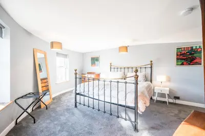 a bedroom with a bed in a room at The Knoll, Alderton in Alderton