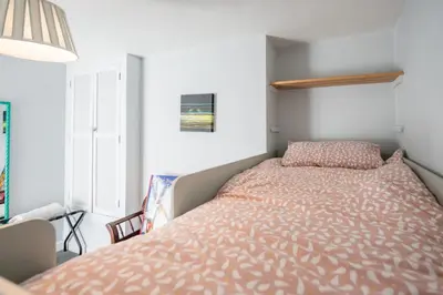 a bedroom with a bed with a orange comforter at The Knoll, Alderton in Alderton