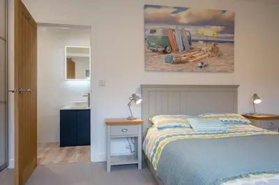 a bedroom with a bed and a painting on the wall at 100 Leiston Road, Aldeburgh in Aldeburgh