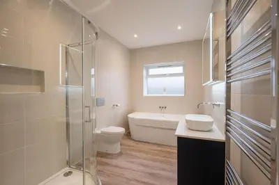 a bathroom with a tub and a toilet and a sink at 100 Leiston Road, Aldeburgh in Aldeburgh