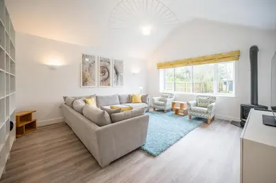 a living room with a couch and a table at 100 Leiston Road, Aldeburgh in Aldeburgh